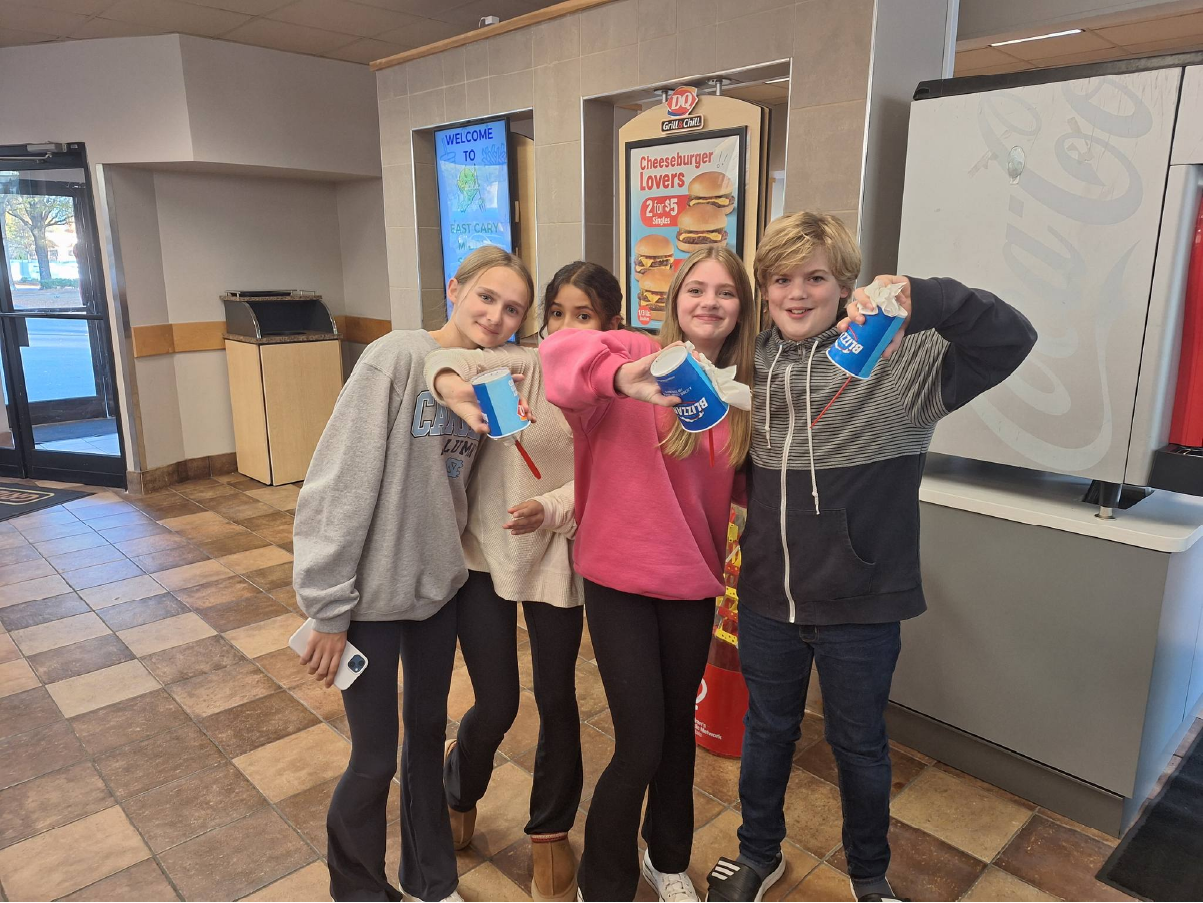 Group of teenagers with upside down ice cream cones